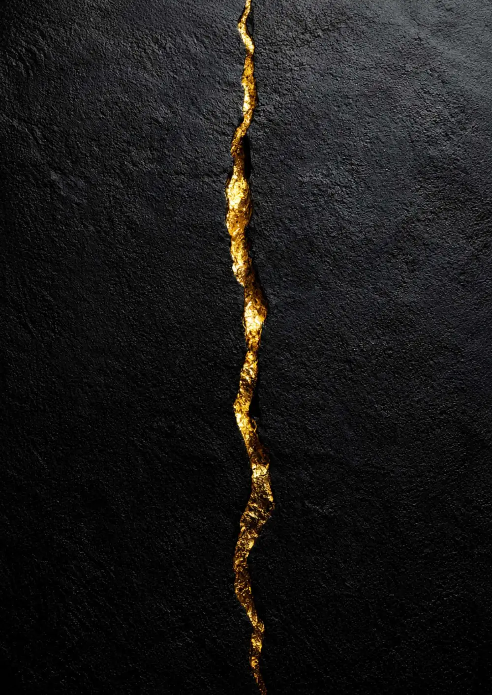 Black textured surface split by a line of gold – Sacred Living